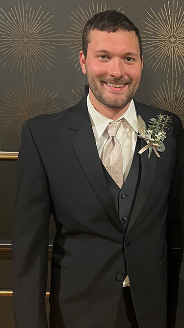 Warren in a suit and tie