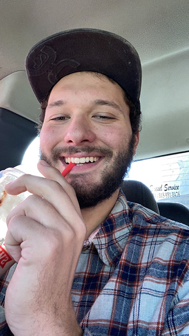 Warren in a car with a soft drink
